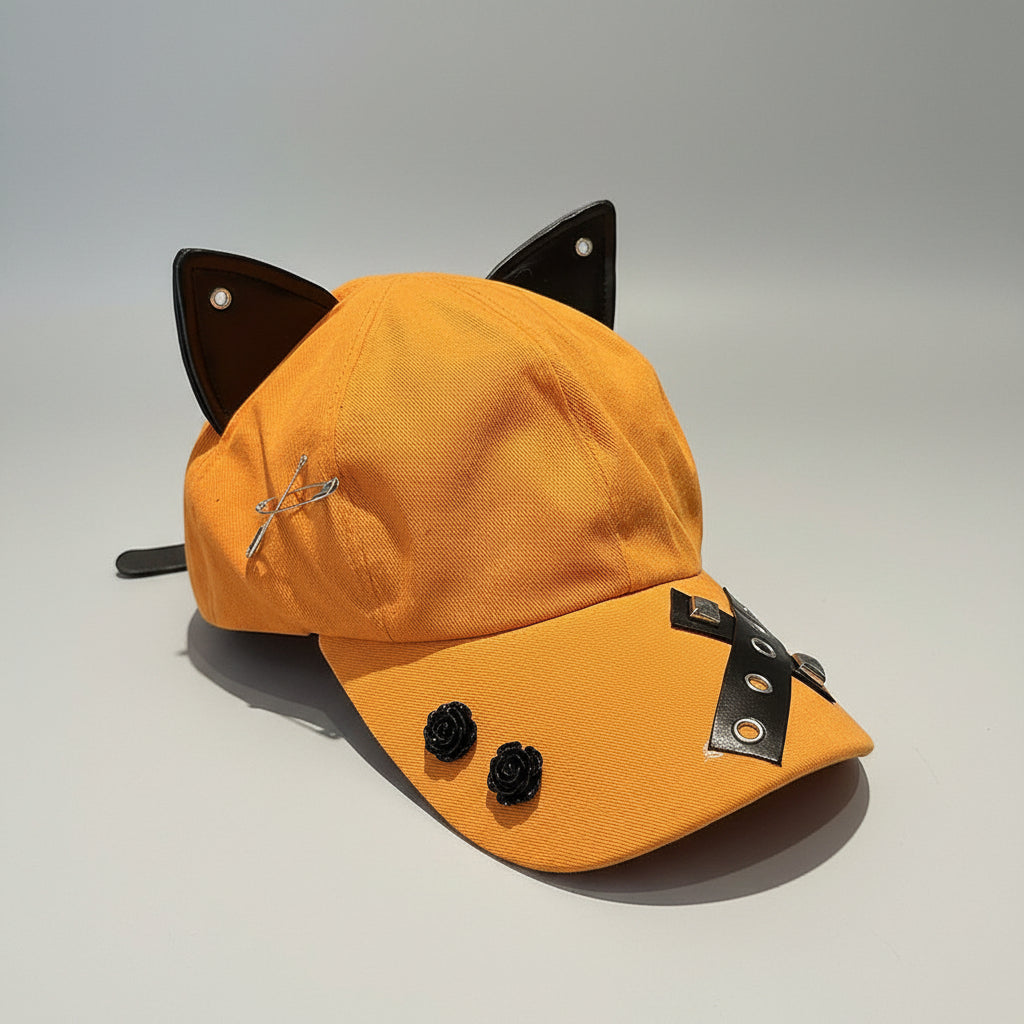 Orange cap with cat ears and black accents on a wooden surface